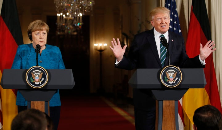 U.S. President Donald Trump speaks as German Chancellor Angela Merkel listens during their joint news conference in the East Room of the White House in Washington on Friday.