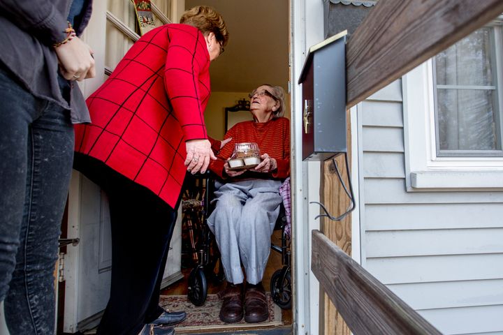 Nancy Brennerman, center, makes a Meals on Wheels delivery to Josephine Hayward, 93, of Portland, Maine, on Christmas Day 2015.