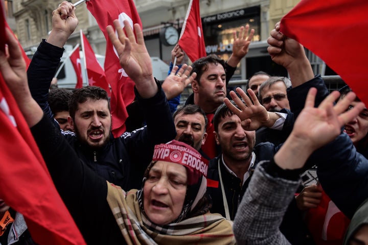 Protesters shout slogans and wave Turkish national flags in front of the Dutch consulate in Istanbul. March 12, 2017.