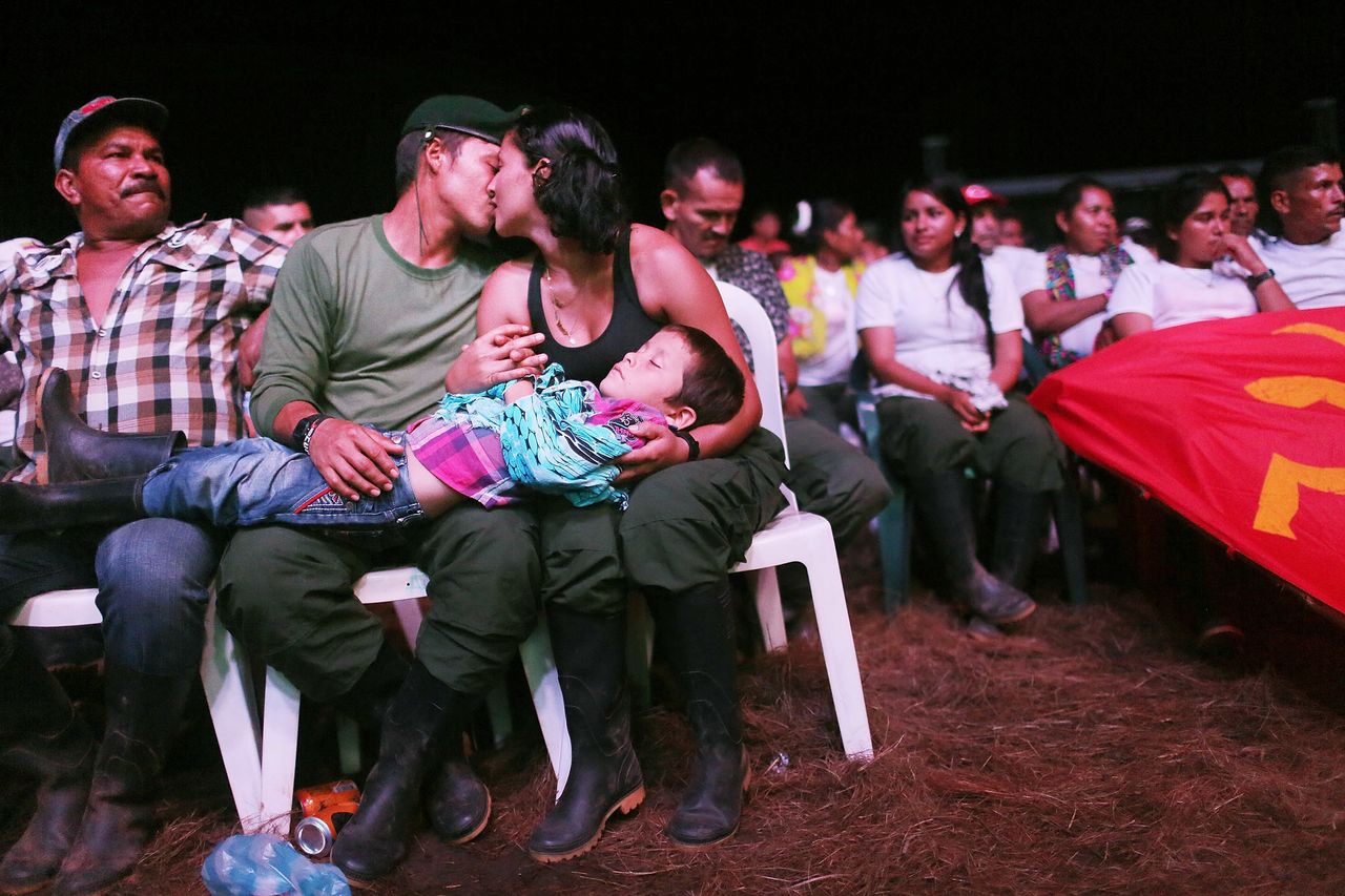 FARC guerrillas Willington and Veronica kiss while holding their nephew at the 10th FARC conference, in the Yari Plains. Sept. 22.