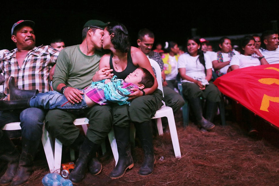 FARC guerrillas Willington and Veronica kiss while holding their nephew at the 10th FARC conference, in the Yari Plains. 
