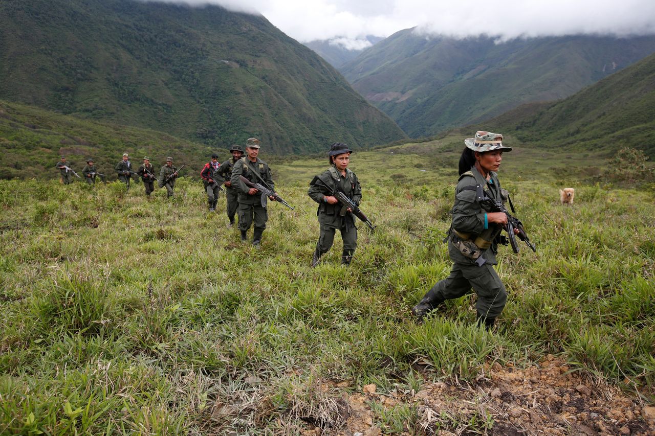 Members of the 51st Front of the FARC patrol in the remote mountains of Colombia. Aug. 16.