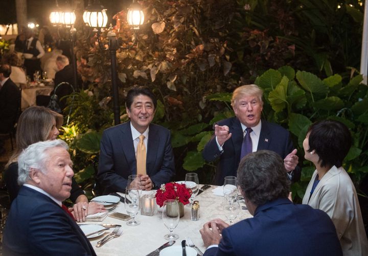 President Donald Trump, Japanese Prime Minister Shinzo Abe (2nd-L), his wife Akie Abe (R), US First Lady Melania Trump (L) and Robert Kraft (2nd-L),owner of the New England Patriots, sit down for dinner at Trump's Mar-a-Lago resort on February 10, 2017.