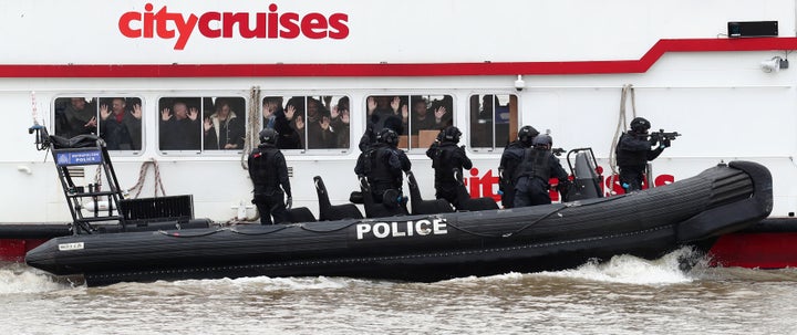 Police officers taking part in a multi-agency exercise, which will test the emergency services' response to a marauding terrorist attack in London, on the river Thames in east London.