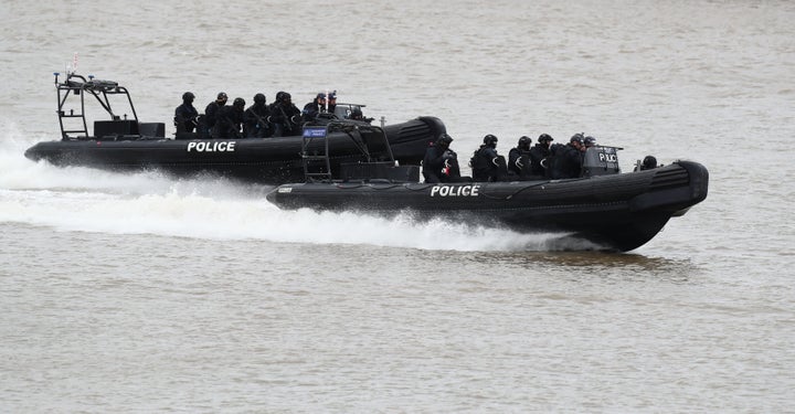 Police officers taking part in a multi-agency exercise, which will test the emergency services' response to a marauding terrorist attack in London, on the river Thames in east London