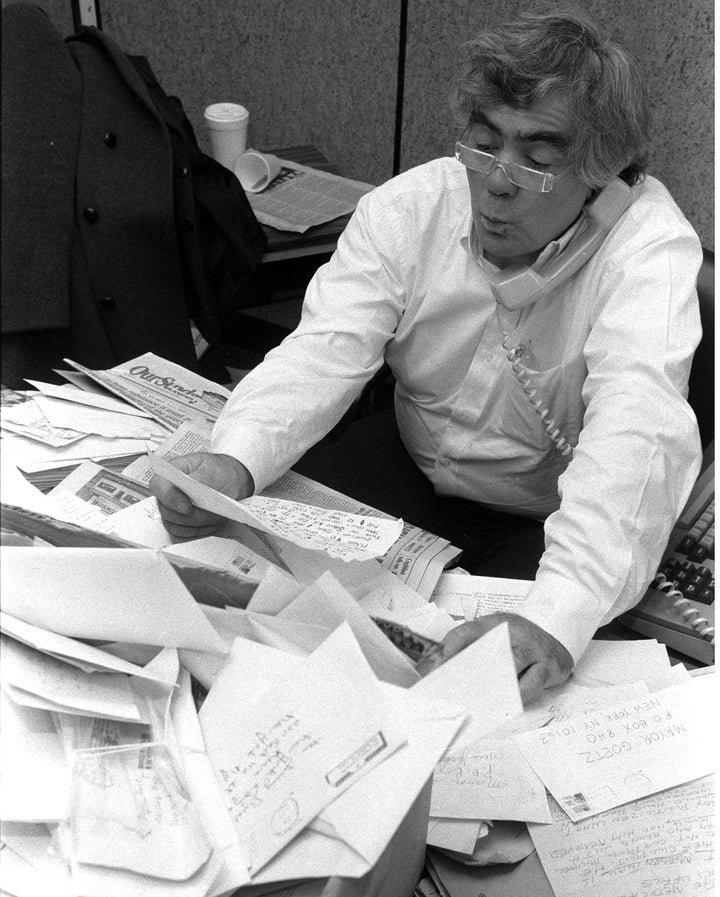 Jimmy Breslin in his office at the Daily News reading his mail