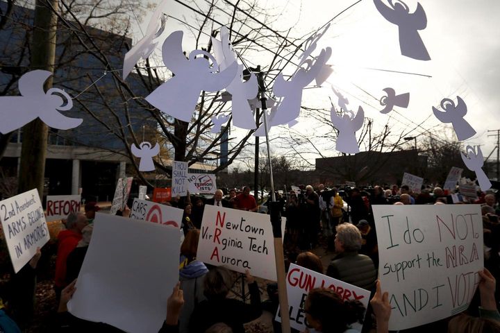 A protester carries a mobile with angels to represent victims of gun violence outside the National Rifle Association headquarters in Fairfax, Virginia December 14, 2015.