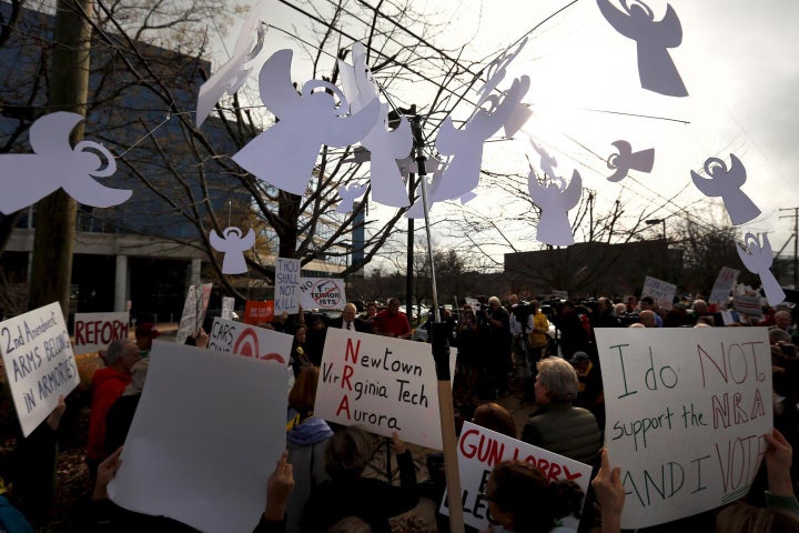 <strong>A protester carries a mobile with angels to represent victims of gun violence outside the National Rifle Association