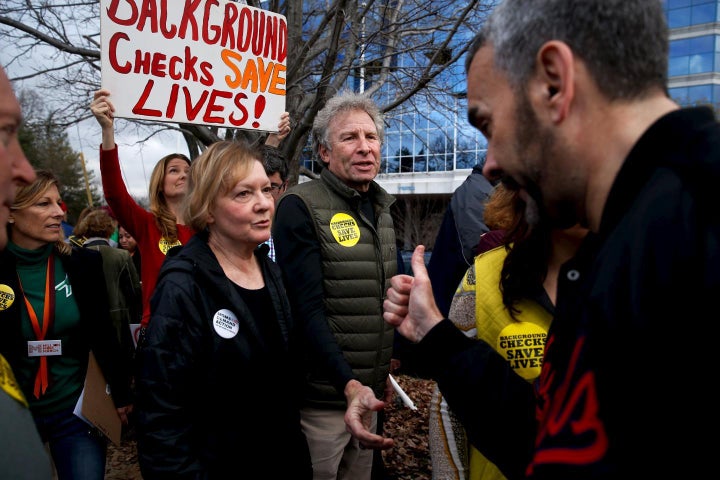 <strong>Author Andy Parker and his wife, Barbara, get a thumbs-up from an activist as they take part in a protest and vigil a