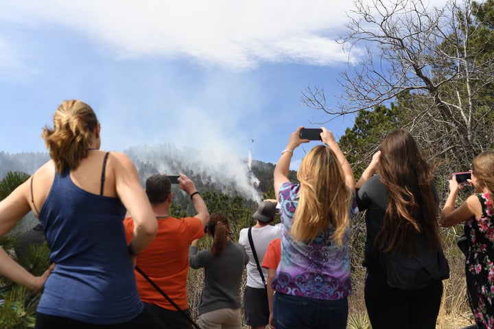 People gather to watch as fire crews work.