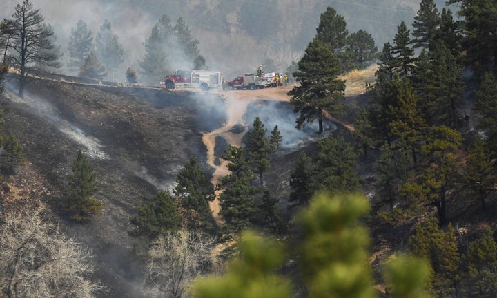 Fire crews work at extinguishing the wildfire in Sunshine Canyon.