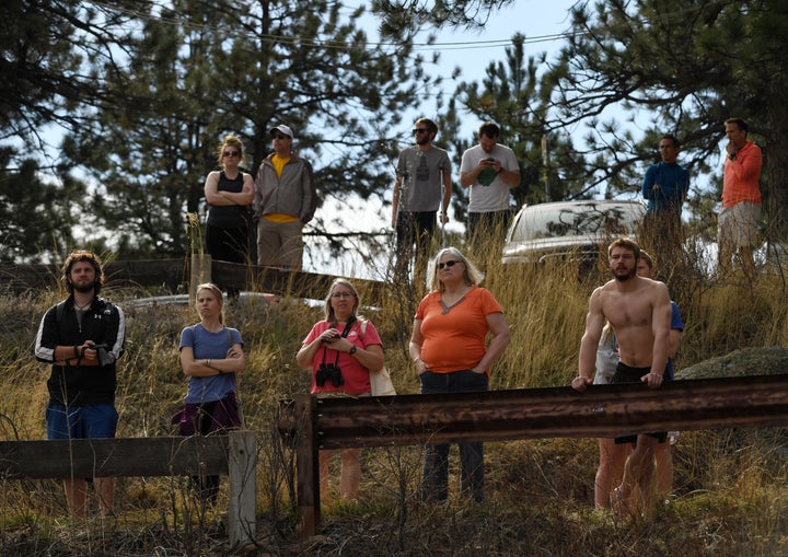 People gather to watch fire crews.