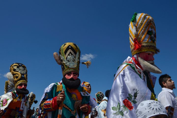 Costumed revelers dance through the streets of Philadelphia for the Carnaval de Puebla on April 27, 2014. 