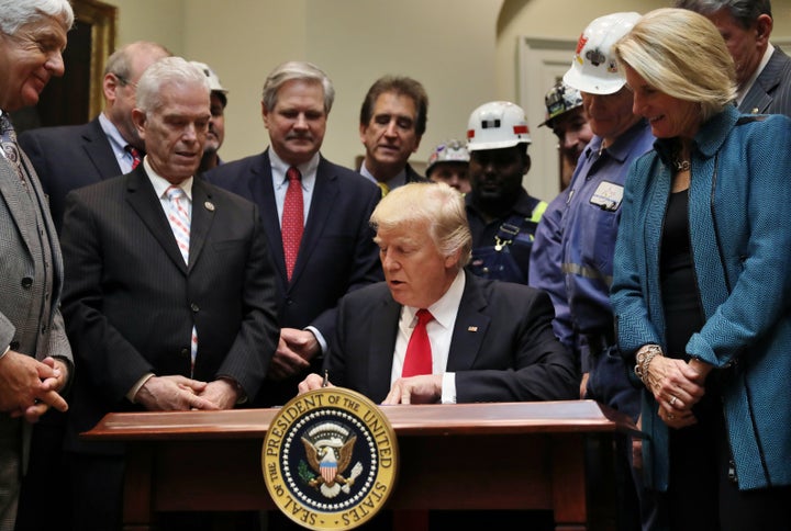 President Donald Trump signs a resolution to nullify the Stream Protection Rule at the White House on Feb. 16, 2017.