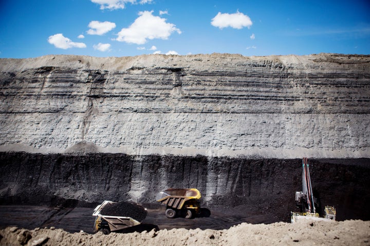 Haul trucks move coal at a mine in Wyoming on June 1, 2016.