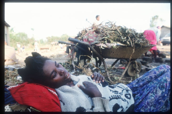 A Tutsi woman lies ill outside the Ruhango refugee camp May 25, 1994, in Rwanda.