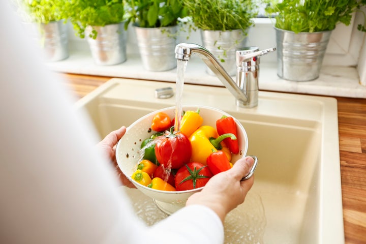Washing produce under water.