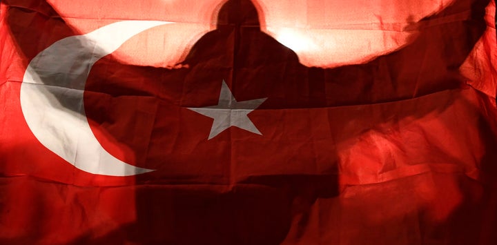 A demonstrator holds a Turkish flag outside the Turkish consulate in Rotterdam in March 2017.