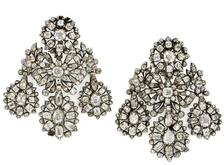<p>Pat Saling’s <em>pair of 18th century diamond girandole earrings, the top circular cluster suspending bow and foliate motifs with three pear shaped cluster drops mounted in silver, </em>circa 1760. </p>