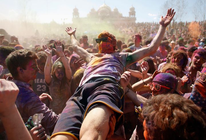 Participants crowd surf, dance and throw colored chalk during the Holi Festival of Colors at the Sri Sri Radha Krishna Temple in Spanish Fork, Utah, March 30, 2013.