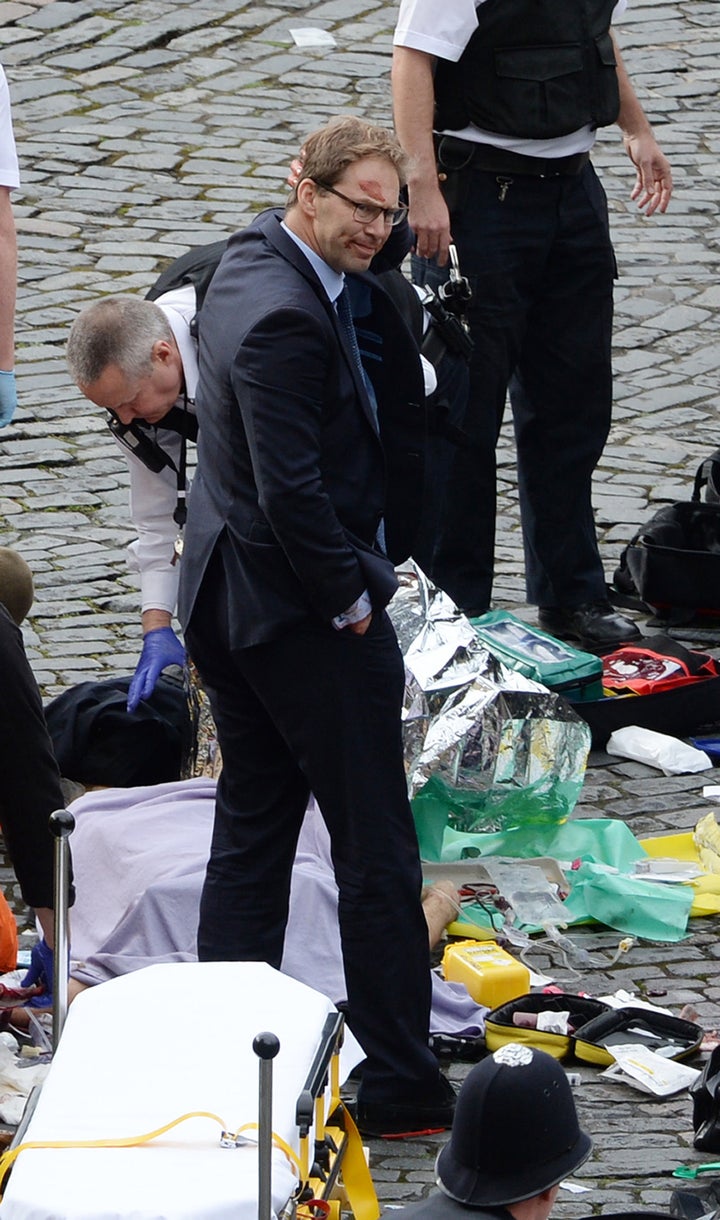 NOTE ALTERNATE CROP Conservative MP Tobias Ellwood stands amongst the emergency services at the scene outside the Palace of W