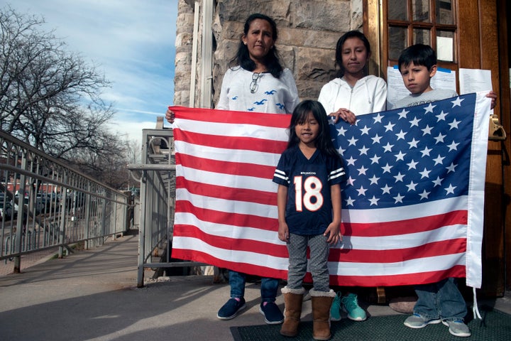 Jeanette Vizguerra and her three U.S.-born children stand outside the First Unitarian Church in Denver, where she took refuge to avoid deportation.