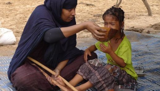 <p>A Mauritanian woman force-feeding a young girl. </p>