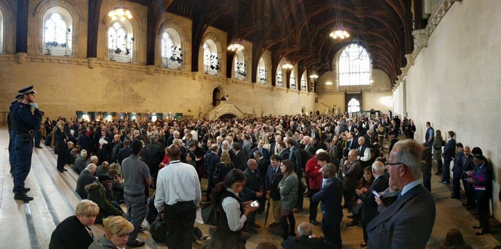 People huddle inside the Houses of Parliament during the security lockdown