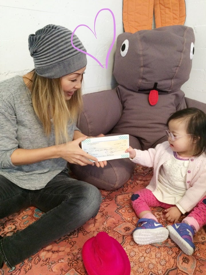 <p>In this photo, I have the privilege of handing sweet Johanna rec room creative’s first donation to the Down Syndrome Connection of the Bay Area. </p>