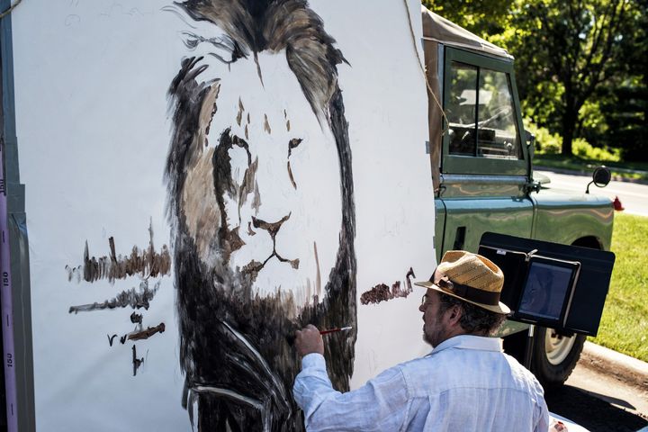 Artist Mark Balma paints a huge mural of Cecil in Dr. Walter Palmer's parking lot on July 29, 2015, at River Bluff Dental in Bloomington, Minnesota.