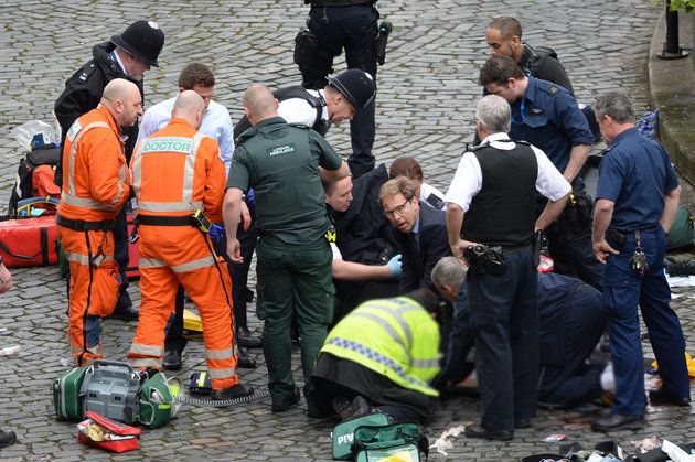 Ellwood (centre with glasses) pictured performing CPR on the injured police officer