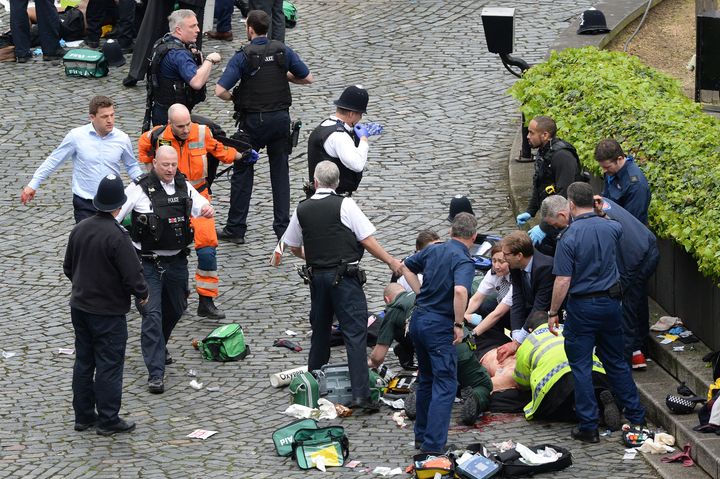 Tobias Ellwood helps paramedics try to save the life of a wounded police officer