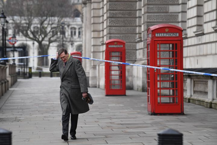 Dominic Grieve passes through the police cordon as he walks along Whitehall
