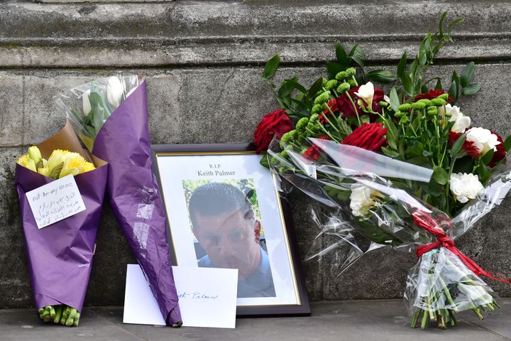 Flowers and a photo of PC Palmer on Whitehall near the Houses of Parliament in London Thursday morning