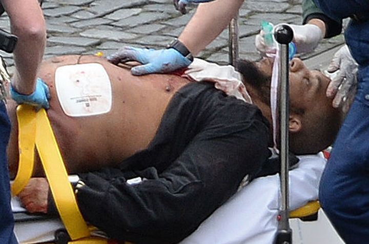 The suspect, since identified as Khalid Masood, is taken away on a stretcher following the attack