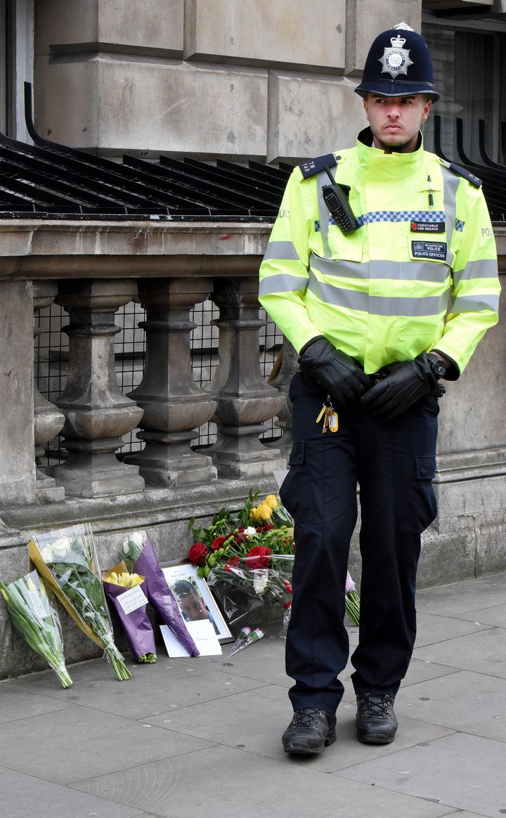 Flowers and a photo of PC Keith Palmer on Whitehall near the Houses of Parliament