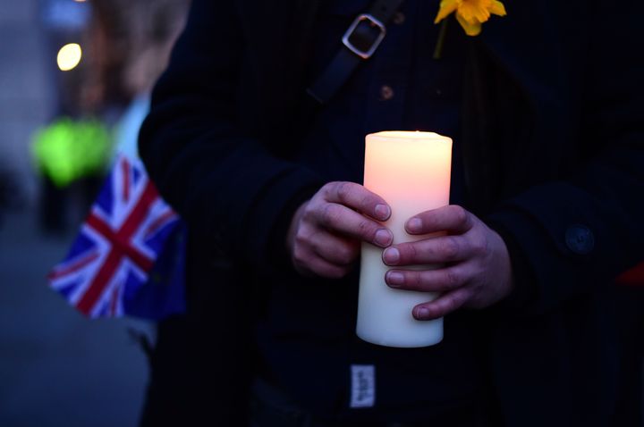 A member of the public holds a candle during the candlelight vigil in Trafalgar Square, London to remember those who lost their lives in the Westminster terrorist attack.
