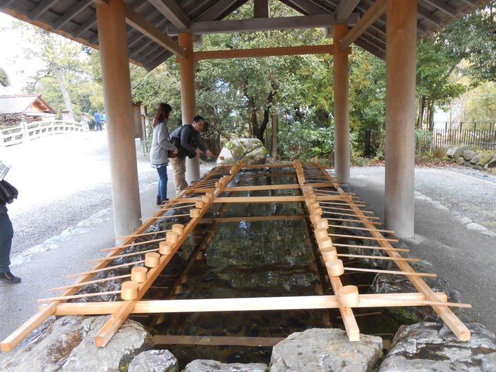 Shinto shrine visitors purify themselves by washing their hands and rinsing their mouth with the pure water.