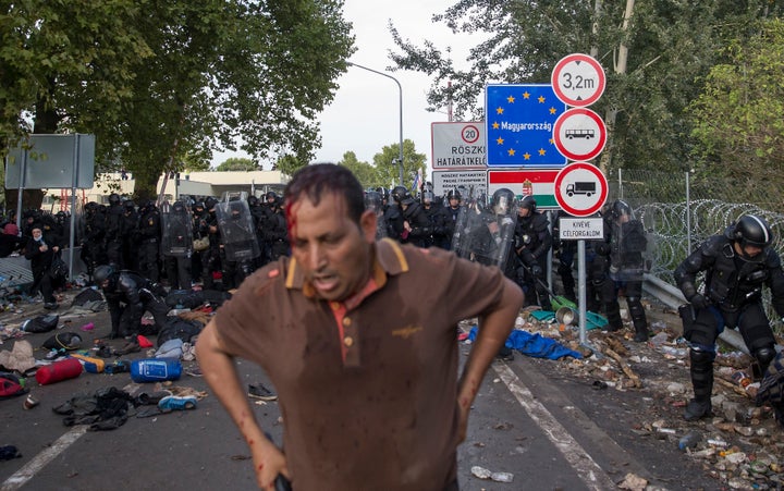 A migrant stands after clashing with Hungarian riot police at the border crossing with Serbia in Roszke, Hungary. Sept. 16, 2