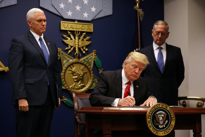 FILE PHOTO: U.S. President Donald Trump signs a travel ban executive order at the Pentagon in Washington, U.S., January 27, 2017.