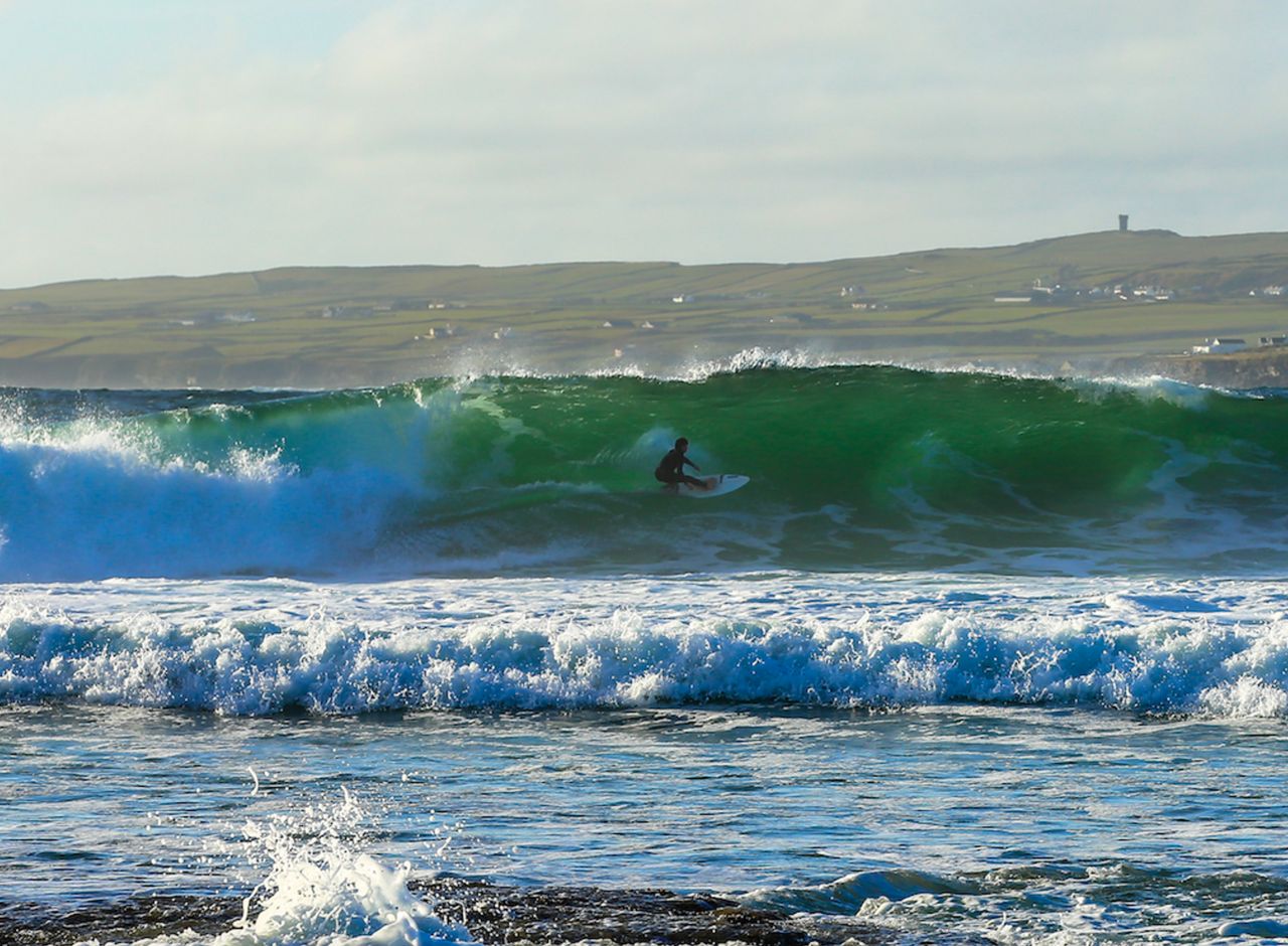 Hennigan pictured surfing in Ireland where he made a 'spiritual connection' that changed his life