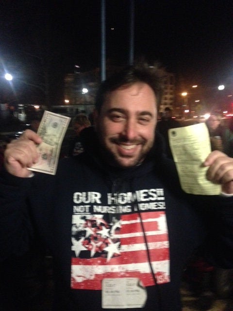 Gregg Beratan holds up money to pay the fine and his summons on Wednesday evening to document his willingness to pay his penalty before he needed to leave Washington.