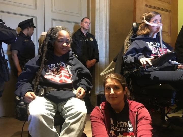 ADAPT activists demonstrate in the Capitol rotunda on Wednesday, March 22, 2017.