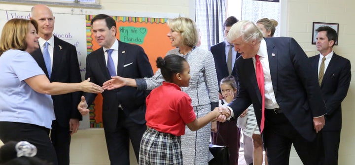 President Donald Trump greets fourth grader Janayah Chatelier on March 3, 2017, in Orlando, Florida.