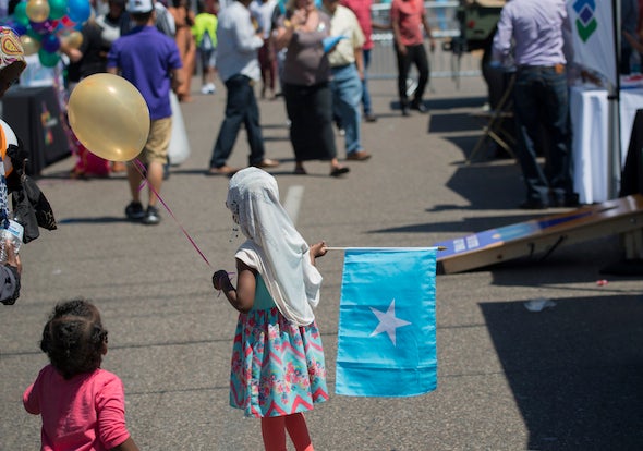<em>A girl holds a Somali flag during a 2016 Somali Independence Day street fair in Minneapolis.</em> <a rel="nofollow" href