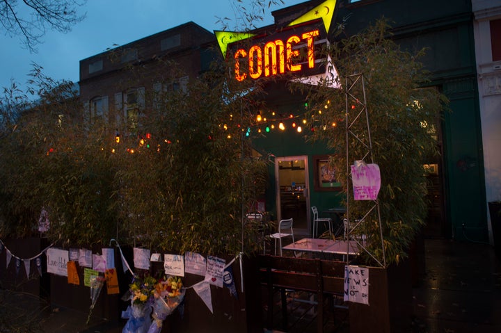 Signs of support hang outside of Comet Ping Pong in Washington, D.C., after an armed man stormed the restaurant in search of abused children.