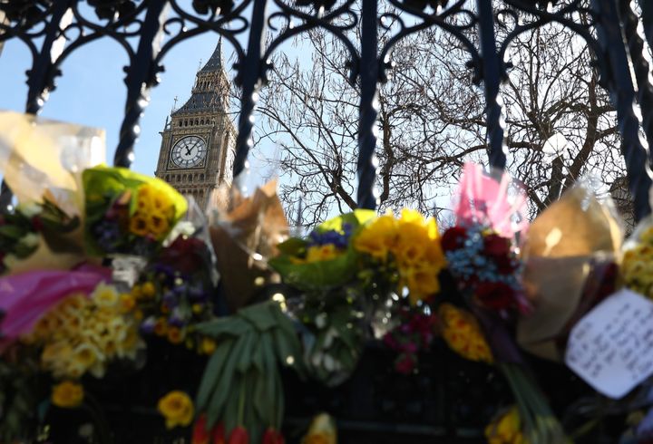 Floral tributes are tied to a fence in Parliament Square following the attack in Westminster earlier in the week, in central London.