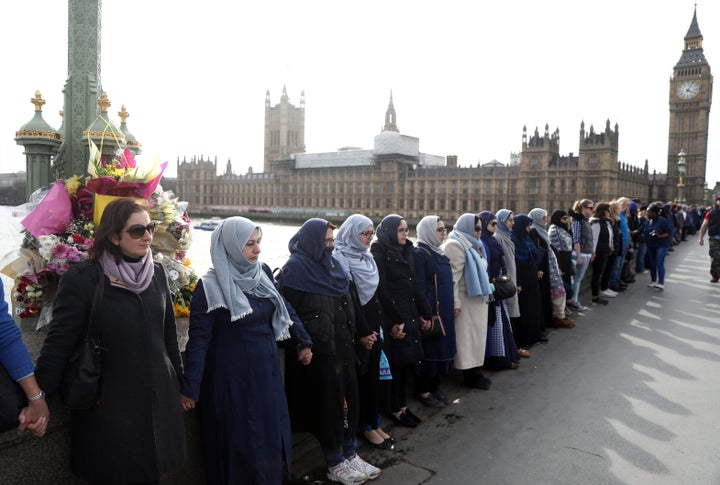 Participants in the Women's March gather on Westminster Bridge to hold hands in silence.