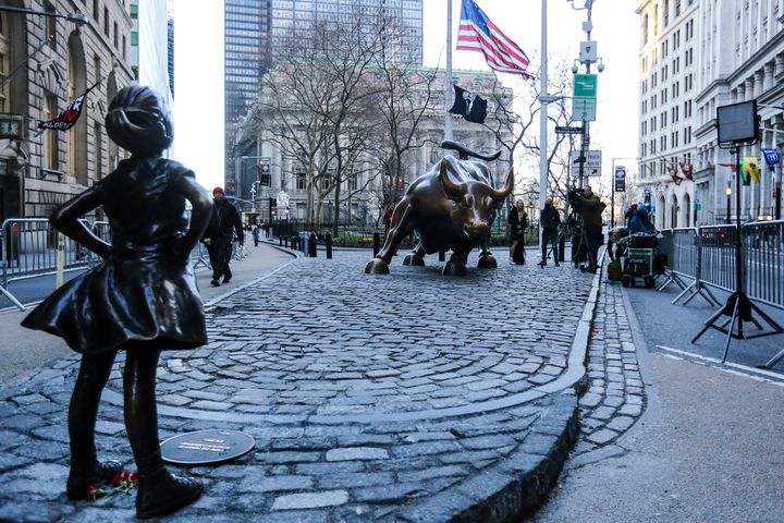 Hundreds of tourists take photos of 'The Fearless Girl' statue as it stands across from the Wall Street's famous Charging Bull.