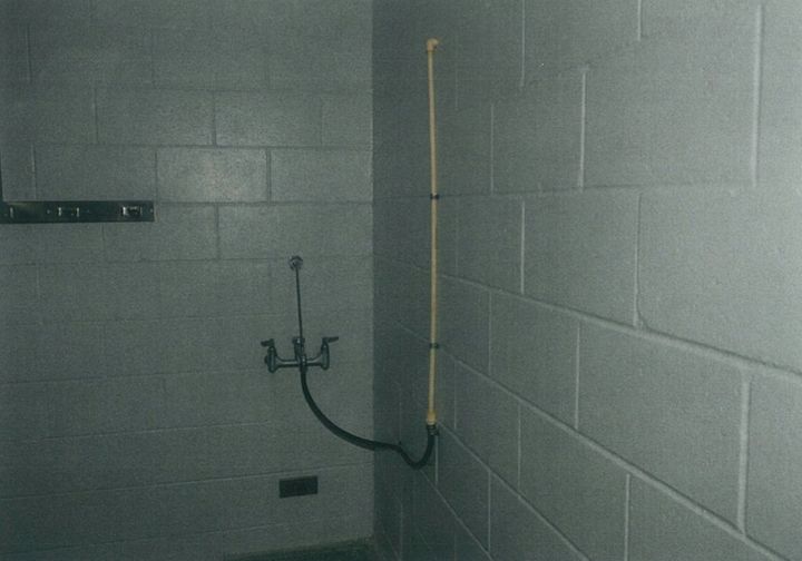 A photo of the janitor's closet adjacent to the shower where inmate Darren Rainey was found dead, showing the rigged-up tubing that provided water to the shower.